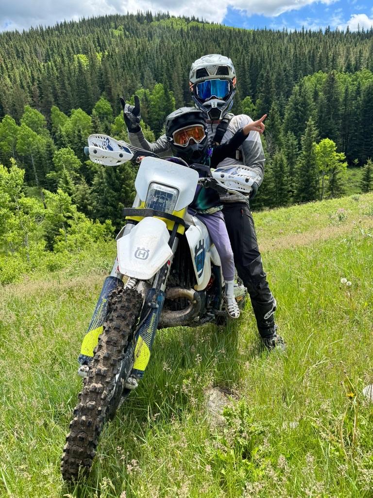 Fabian and his child on a dirt bike in the mountains