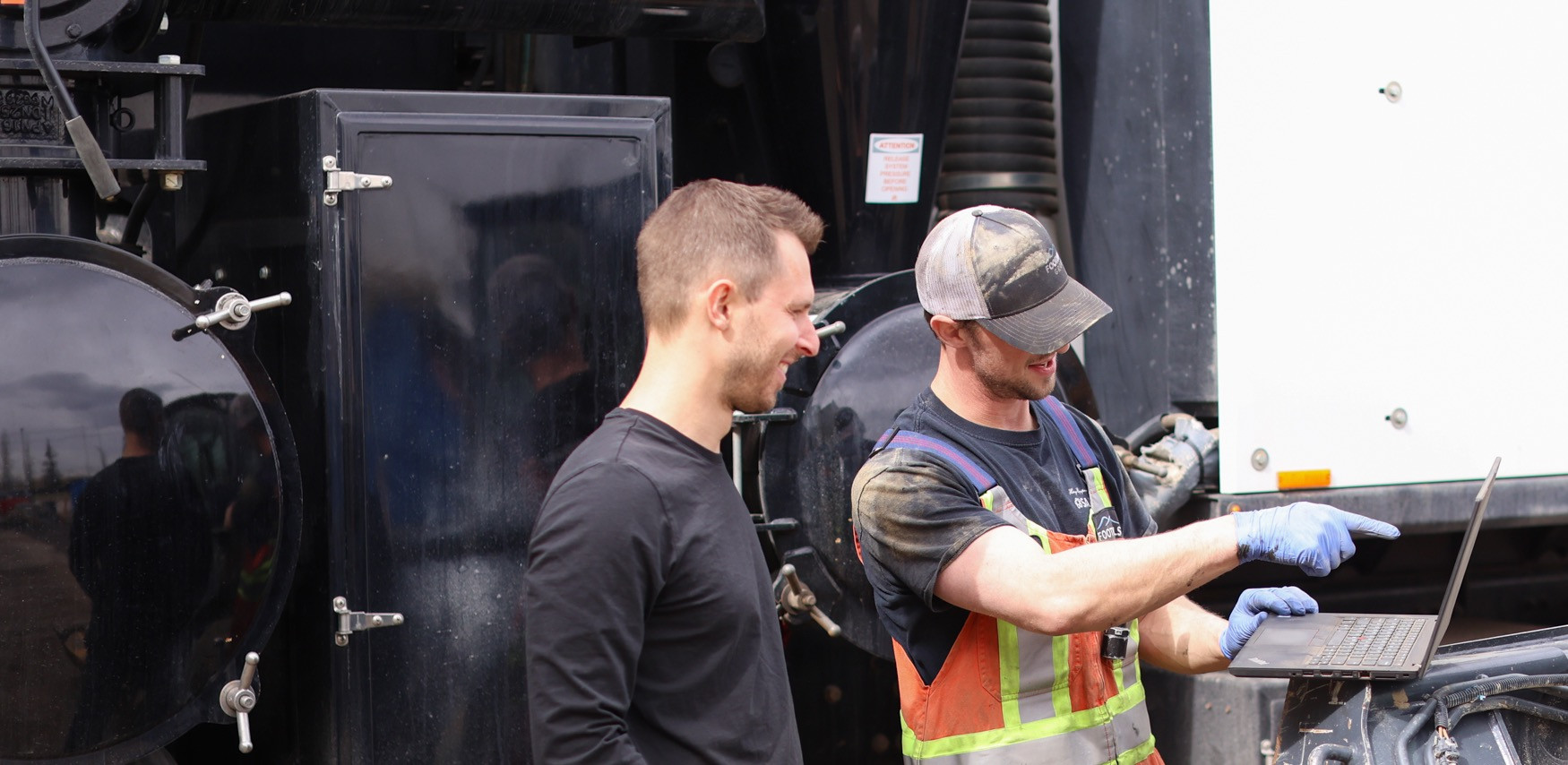 Fabian Bonjean and a Foothills technician reviewing a job on a laptop