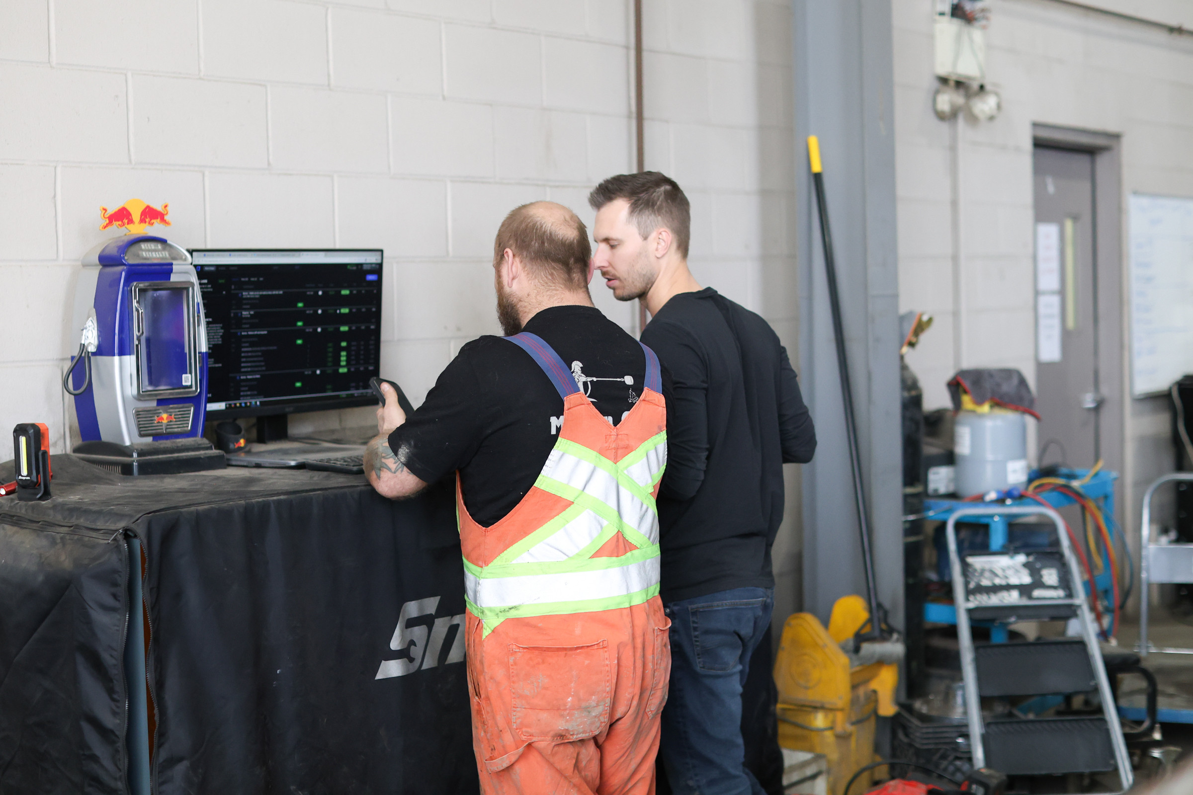 Fabian and a technician reviewing ShopView on a shop workstation