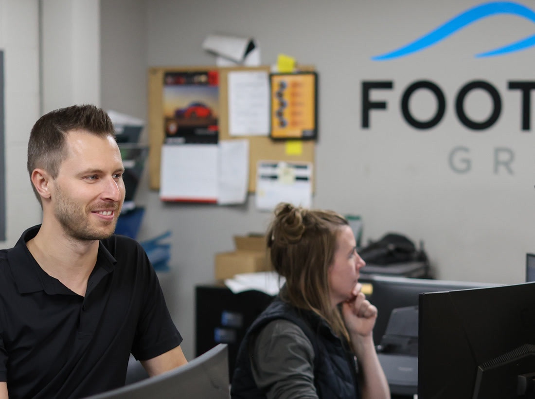 Fabian and a teammate at the Foothills Group counter
