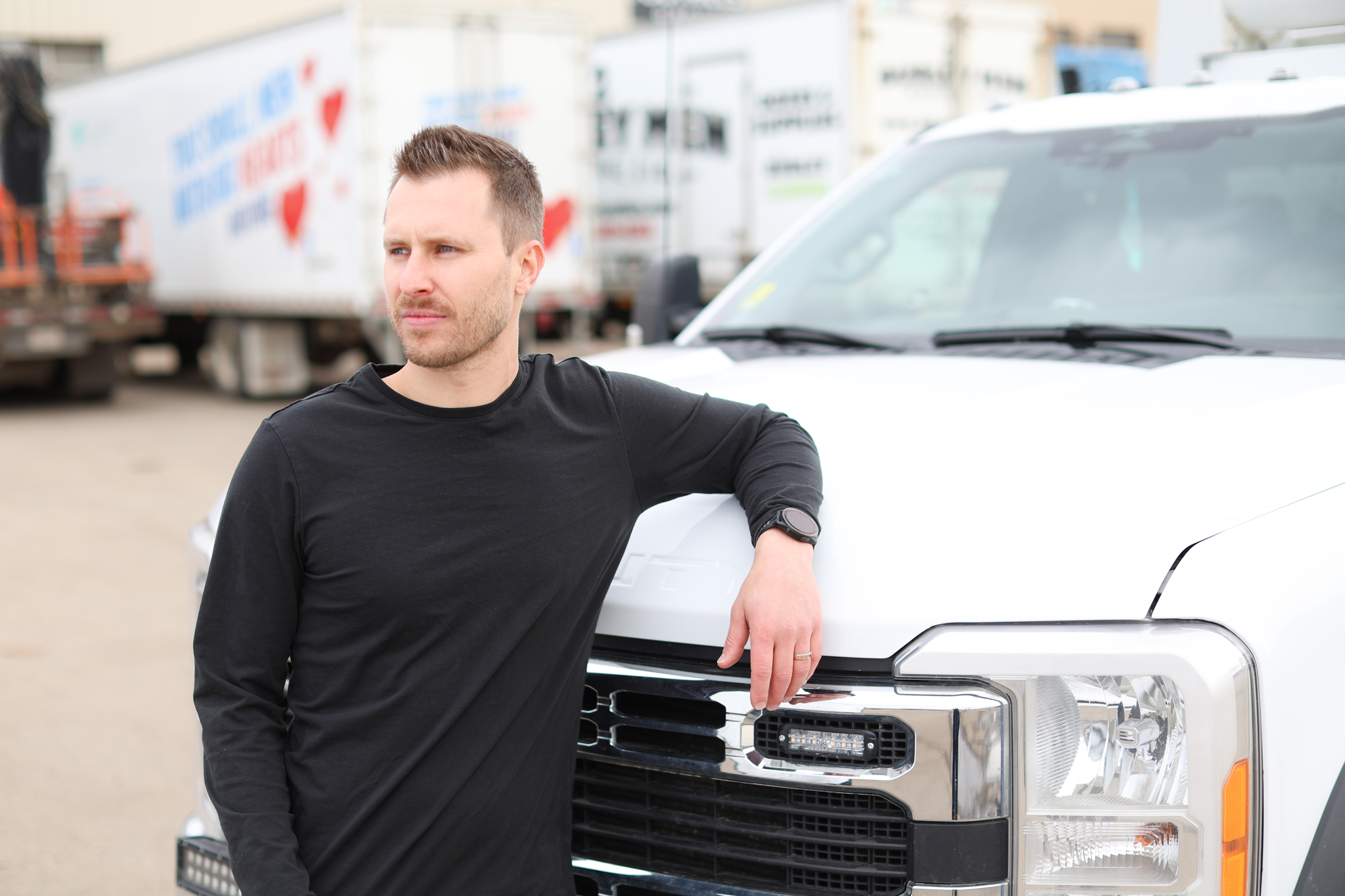 Fabian Bonjean leaning against a white pickup in a truck yard